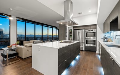 Contemporary kitchen with expansive island and panoramic Phoenix views, enhanced by energy-efficient appliances and modern finishes.