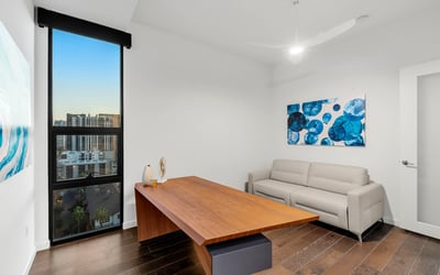 Contemporary room ideal for remote work or guest accommodations, with clean design, updated flooring, and bright Phoenix views.