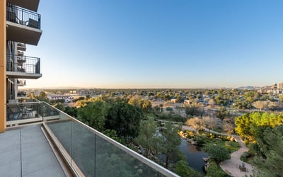 Elevated balcony overlooking landscaped park areas and walking paths, creating a peaceful outdoor space in Phoenix.