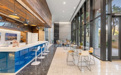 Light-filled lobby featuring expansive glass walls and contemporary furnishings, enhancing the modern feel of this Phoenix property.