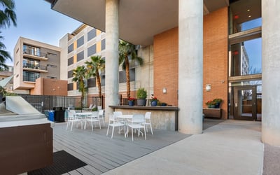 Outdoor patio with dining tables and grilling station, providing a functional space for gatherings in Phoenix.