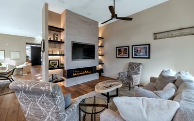 Contemporary fireplace wall with built-ins and warm finishes, adding both style and function to this Phoenix home s main living area.
