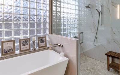 Contemporary glass shower with detailed tile work and upgraded fixtures, enhancing the bathroom design in this Phoenix home.