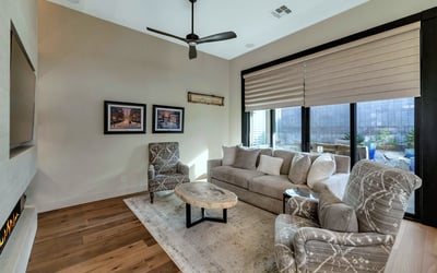 Living room with large sliding doors and natural light, offering easy access to outdoor living spaces in this Phoenix home.