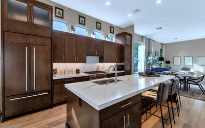Beautiful kitchen featuring quartz counters, ample cabinetry, and a large island ideal for cooking and entertaining in this Phoenix home.