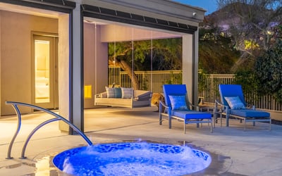 Serene spa with bubbling water feature next to a covered seating area, offering a private Scottsdale outdoor escape for relaxation and entertaining.