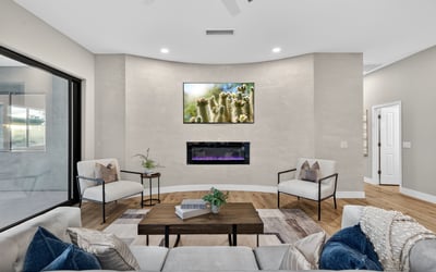 Contemporary Scottsdale living room showcasing a sleek fireplace, neutral tones, and updated finishes, creating a comfortable and stylish gathering space.