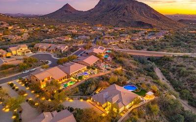 Scottsdale aerial showing the neighborhood at sunset with desert landscaping, homes, and warm evening lighting.