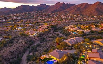 Scottsdale aerial showcasing natural desert terrain, nearby homes, and open space enhancing privacy and views.