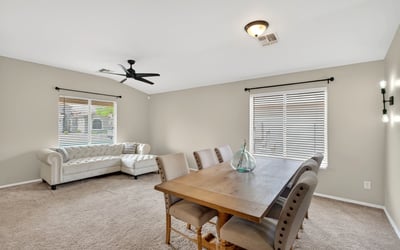 Dining area with large windows and inviting atmosphere. Ideal for gatherings and everyday meals in this Casa Grande home.