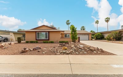 Wide driveway and open front yard offering plenty of parking and easy access. This Sun City home combines functionality with attractive desert landscaping.