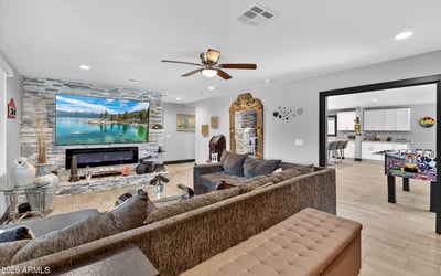 Open layout connecting living and kitchen spaces, featuring recessed lighting and contemporary updates in this Phoenix property.