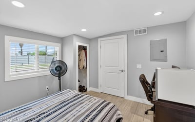 Light-filled bedroom featuring updated flooring, closet space, and a functional layout.