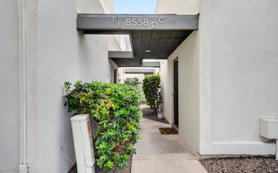 Quiet Scottsdale entry courtyard with covered patio and desert landscaping provides a peaceful, low-maintenance outdoor space.
