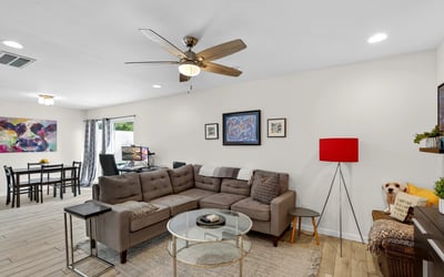 Light-filled Scottsdale living space with ceiling fan, updated flooring, and open-concept design that enhances comfort and functionality.