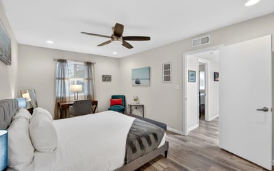 Comfortable Scottsdale bedroom with ceiling fan, updated flooring, and generous space for relaxing and unwinding.