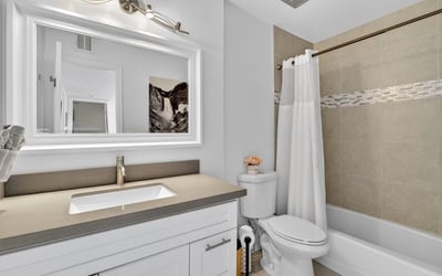 Scottsdale bathroom with modern vanity, framed mirror, and tiled tub-shower combo, delivering style and everyday convenience.