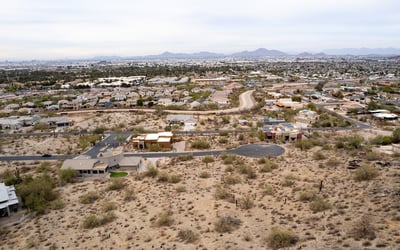 Featured aerial view of this spacious hillside lot showcasing elevated terrain and scenic desert beauty. Perfect for a luxury custom home near South Mountain Preserve and outdoor recreation.
