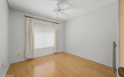 This comfortable bedroom features durable flooring, neutral colors, and excellent natural light. The flexible space can function as a guest room, office, fitness room, or additional sleeping area.