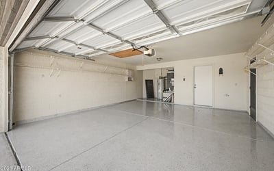 Offering extensive shelving, durable flooring, and generous parking capacity, this garage is designed for organization and convenience. The spacious layout accommodates vehicles, tools, and seasonal storage with ease.