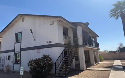 Inviting exterior perspective showcasing the property's well-kept grounds, designated parking, and mature landscaping. Residents enjoy a convenient Glendale location near dining, retail, and recreational opportunities.