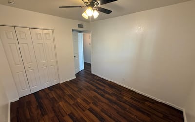Well-sized bedroom with generous closet storage, ceiling fan, and attractive flooring. Ideal as a guest room, home office, or primary sleeping area within this Glendale apartment home.