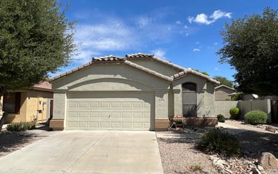 Well-maintained single-level home with a two-car garage, wide driveway, and mature landscaping that enhances curb appeal. The inviting exterior reflects the comfortable lifestyle and convenience offered in this sought-after Goodyear location.
