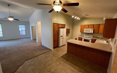 Kitchen overlooks the main living area, creating a connected and spacious feel throughout the home. Ample storage and counter space support both daily routines and entertaining needs.