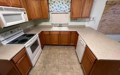 Well-organized kitchen featuring extensive countertops, plentiful cabinetry, and practical work areas. Ideal for meal preparation, hosting gatherings, and keeping everyday essentials within easy reach.