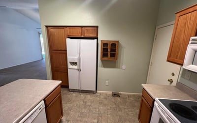 Well-appointed kitchen offering extensive cabinetry, pantry storage, generous counter space, and included appliances. Designed for convenience, this space supports both meal preparation and everyday living.
