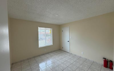 Bright bedroom featuring a modern ceiling fan, neutral color palette, and easy-care tile flooring. The flexible floor plan accommodates a variety of lifestyle needs.