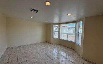 Charming flex room enhanced by attractive bay windows that create a bright and welcoming atmosphere. Perfect for a home office, sitting room, hobby space, or additional bedroom, this versatile area offers endless possibilities.