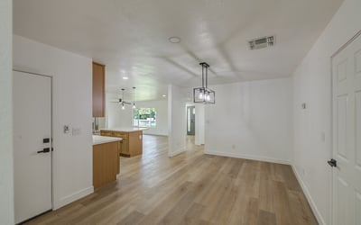 Spacious and filled with modern appeal, the dining room features updated flooring, designer lighting, and an open layout that enhances everyday comfort.