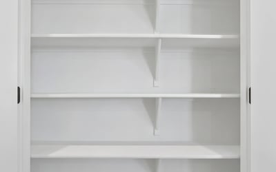This generously sized pantry offers multiple built-in shelves to keep kitchen essentials organized while maximizing storage and convenience for everyday living.