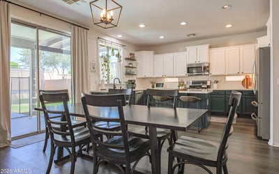 Spacious dining room with backyard views, large sliding glass doors, and an open connection to the updated kitchen, creating a bright and inviting entertaining space.