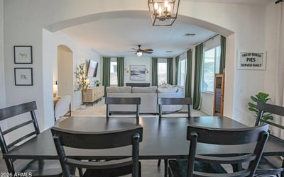 Spacious dining room overlooking the inviting family room through an elegant arched opening, creating a seamless layout that's perfect for entertaining and everyday gatherings.