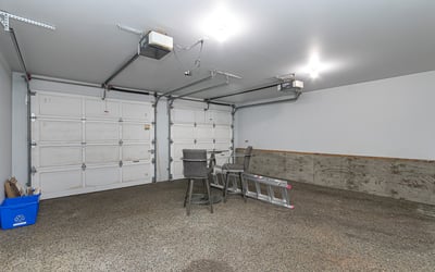 Spacious garage with ample room for storage, featuring high ceilings and convenient overhead lighting.