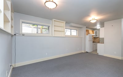 Bright, versatile space with ample natural light, perfect for a home office or cozy gathering area.