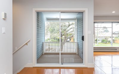 Bright and inviting space with sliding glass doors leading to a cozy patio and garden view.