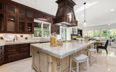 Spacious kitchen featuring a central island, modern appliances, and abundant natural light from large windows.