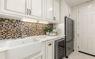 Modern Laundry room featuring a unique mosaic backsplash, spacious sink, and upgraded stainless steel appliances (Fridge and Wine Fridge included)
