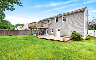 Spacious backyard with large deck and patio.