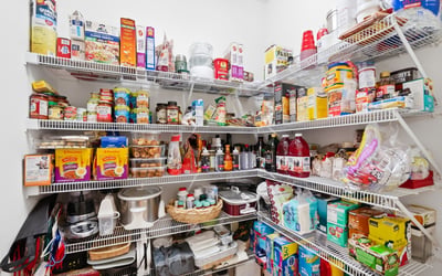 Spacious pantry with ample shelving, ideal for organized storage of food and household essentials.
