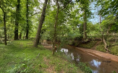 The Little River forms the natural border at the back of the property, creating a peaceful wooded backdrop and a rare sense of privacy. It s the kind of setting that makes the acreage feel even more special quiet, natural, and beautifully connected to the land.