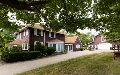 Spacious two-story home with modern amenities, a large yard, and a separate garage for ample storage.