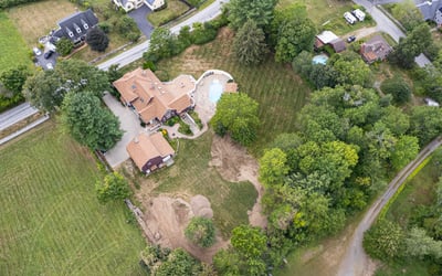 Stunning property featuring a spacious home, inviting pool, and expansive landscaped grounds in a peaceful setting.
