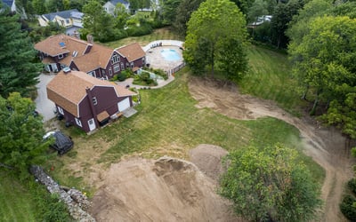Spacious property featuring a large pool area, surrounded by lush greenery and ample outdoor space.