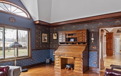 Spacious living area featuring unique architectural details and rich wood finishes, perfect for relaxation and gatherings.