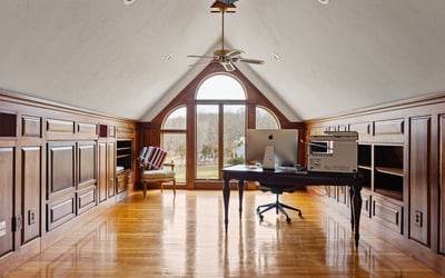 Bright and airy loft office with expansive windows, custom cabinetry, and stunning panoramic views.