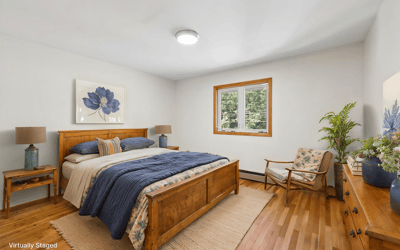 Bright and airy bedroom featuring warm wood accents, natural light, and inviting decor for ultimate comfort.
